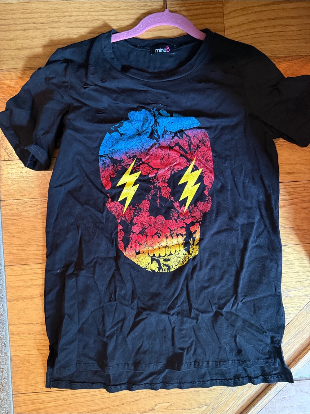 mineB Black Tee with Colorful Floral Skull Graphic
Little cuts part of design